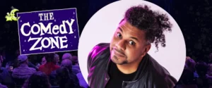 Comedian Orlando Leyba smiling with raised eyebrows, next to "The Comedy Zone" logo and audience.