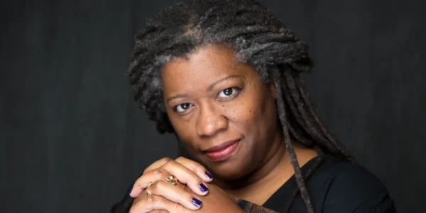 Posed for a photo is storyteller and artist, Donna Washington.