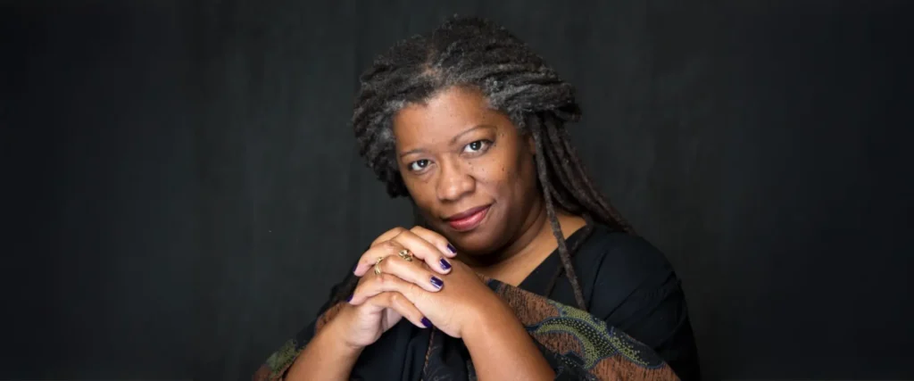 Posed for a photo is storyteller and artist, Donna Washington.