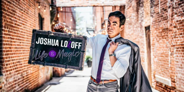 Magician Josh Lozoff holding a sign for his 