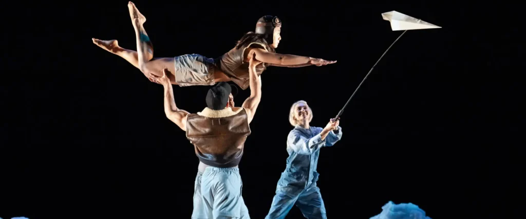Photo of Pilobolus dancers lifting each other in the air while performing their piece 