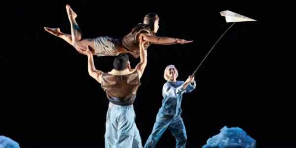 Photo of Pilobolus dancers lifting each other in the air while performing their piece 