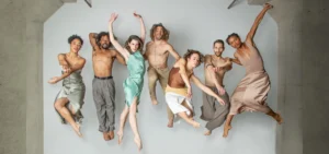 Photo: seven dancers from BODYTRAFFIC posed jumping in mid-air