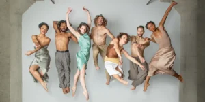 Photo: seven dancers from BODYTRAFFIC posed jumping in mid-air
