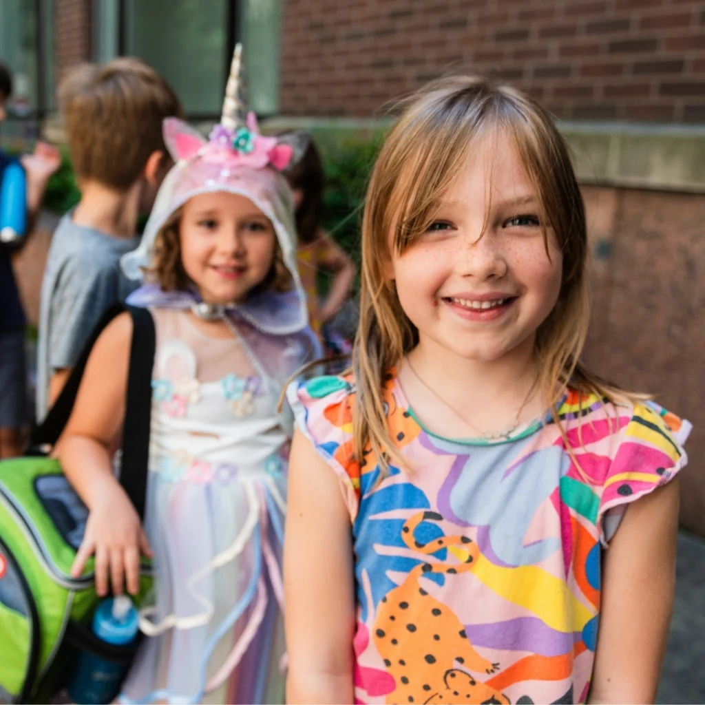 Photo: two students pictured smiling outside the Wortham Center for creative arts summer camp
