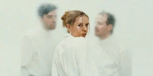 Photo: two men and one woman of Stundom; photo has a moody, off-white colorcast