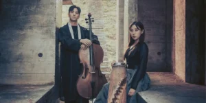 Photo: woman in black dress with a gayageum and man with a cello posed together