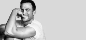 Photo: studio headshot of Cheyenne Jackson smiling at camera