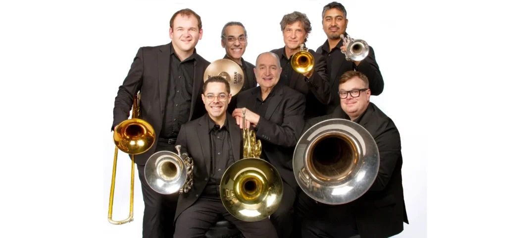 Photo: seven members of Dallas brass; artistic director, two trumpet players, tubist, French hornist, trombonist, and percussionist