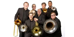 Photo: seven members of Dallas brass; artistic director, two trumpet players, tubist, French hornist, trombonist, and percussionist