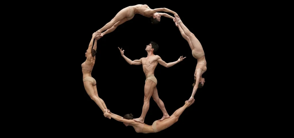 Photo: dancers from NoGravity Theatre in a mid-air circle